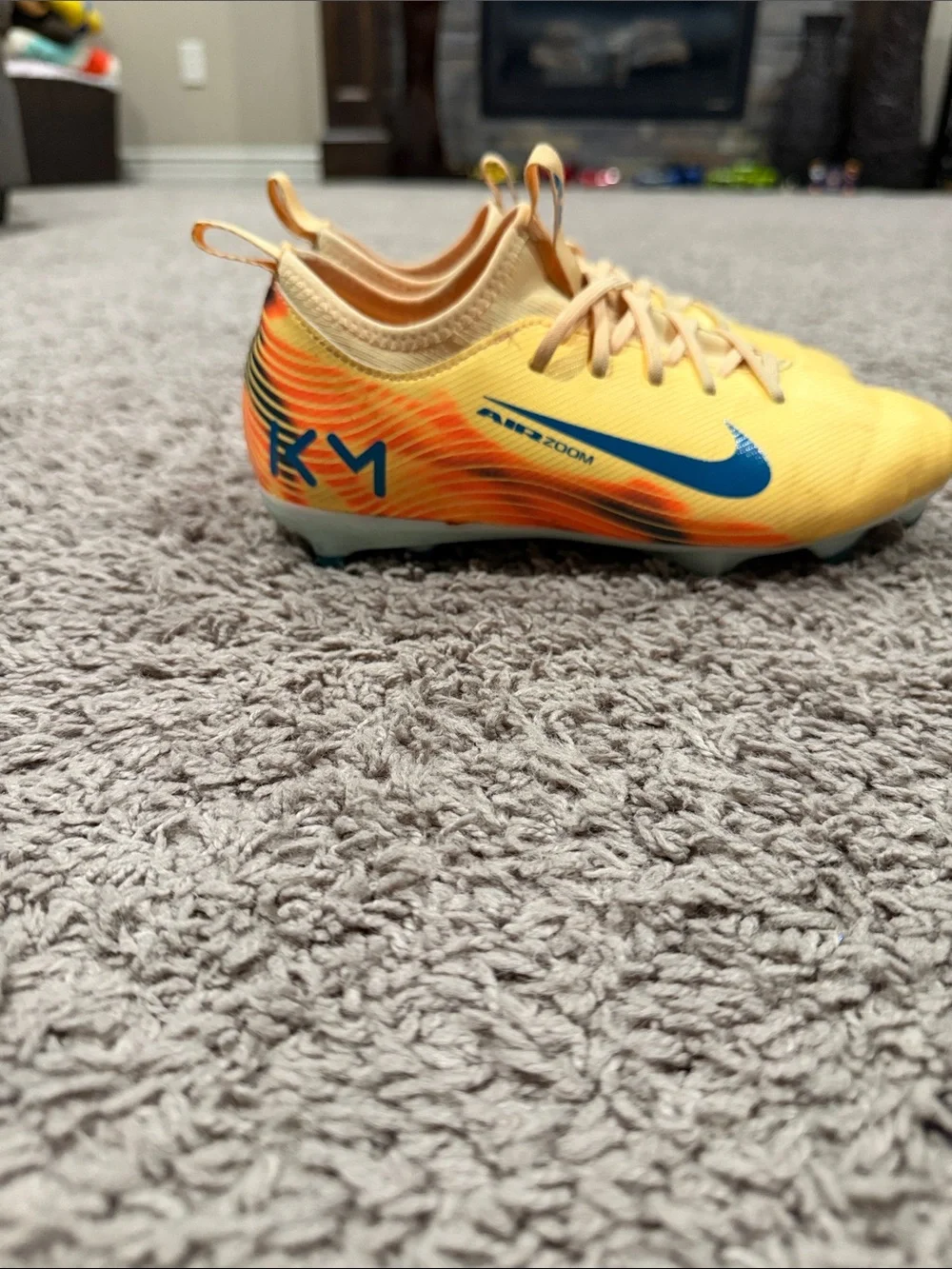 Nike Yellow Soccer Cleats with Blue Swoosh and Orange Accents